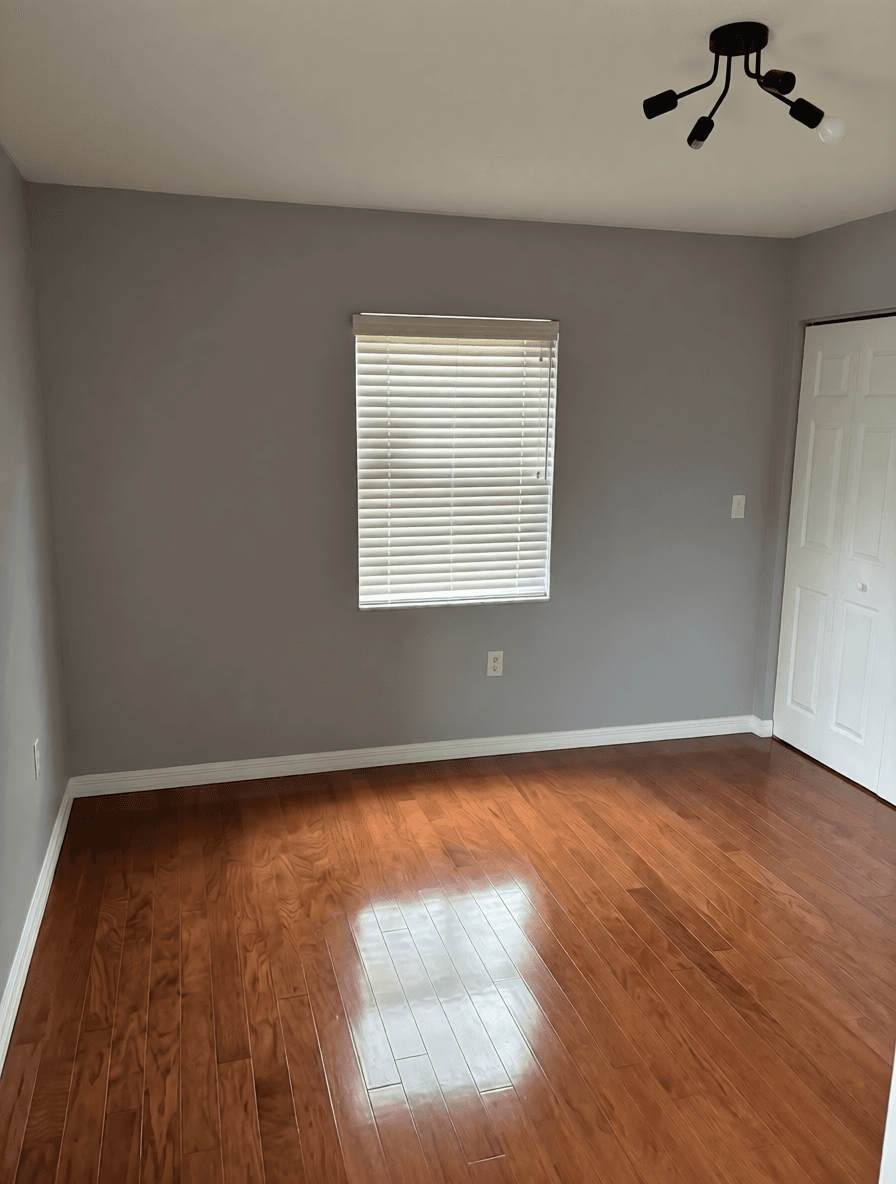 Bedroom with fresh paint and hardwood floors